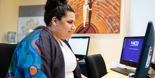 An Indigenous student working on a computer