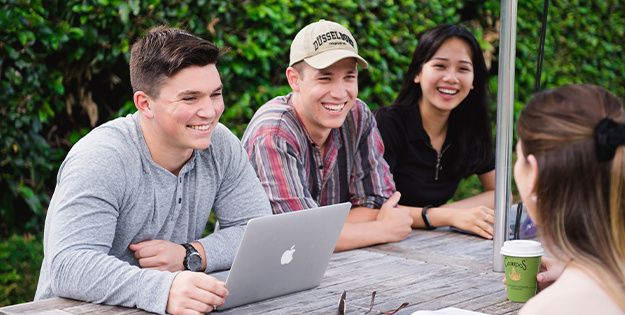 Group of friends sitting at table outside at North Sydney Campus