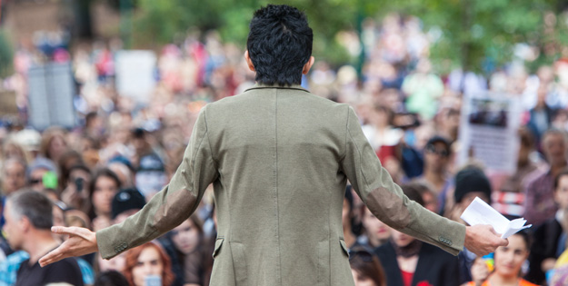 Lady's back facing a rally of students
