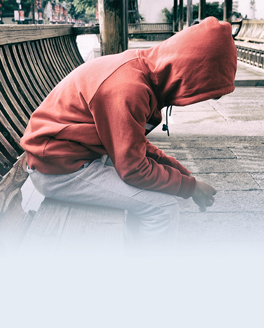 Suspended boy sitting alone out of school