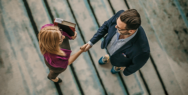 Overhead shot of man and woman shaking hands