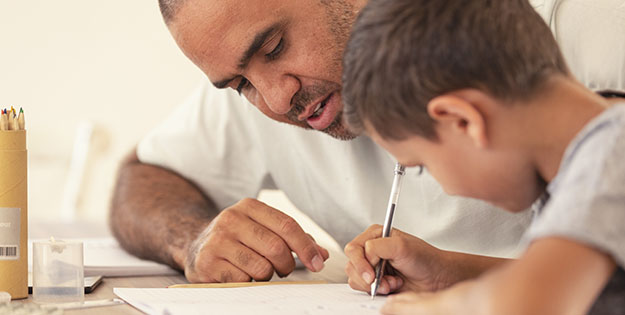 Aboriginal man teaching young sun to read
