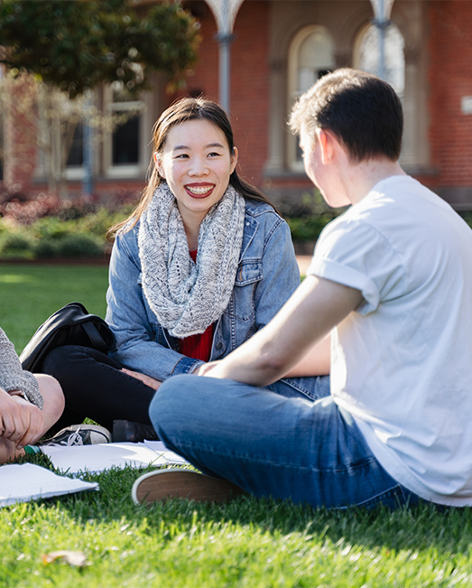 Two students on the Ballarat Campus lawn