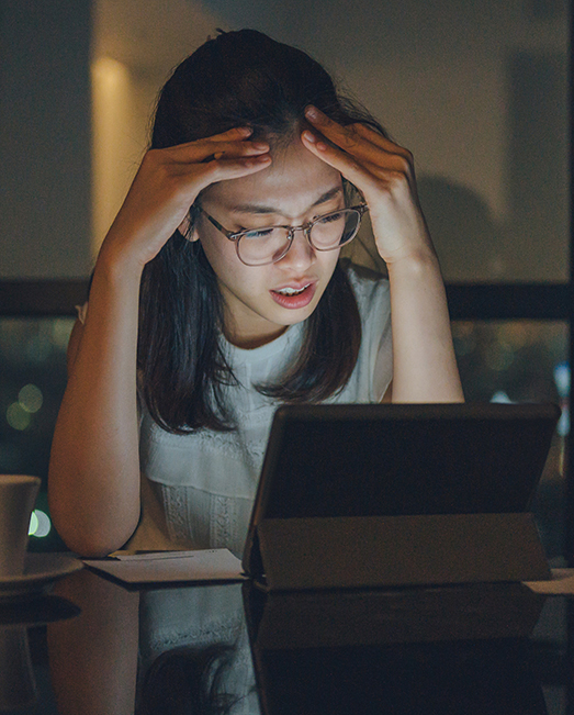 Overworked woman stares at computer