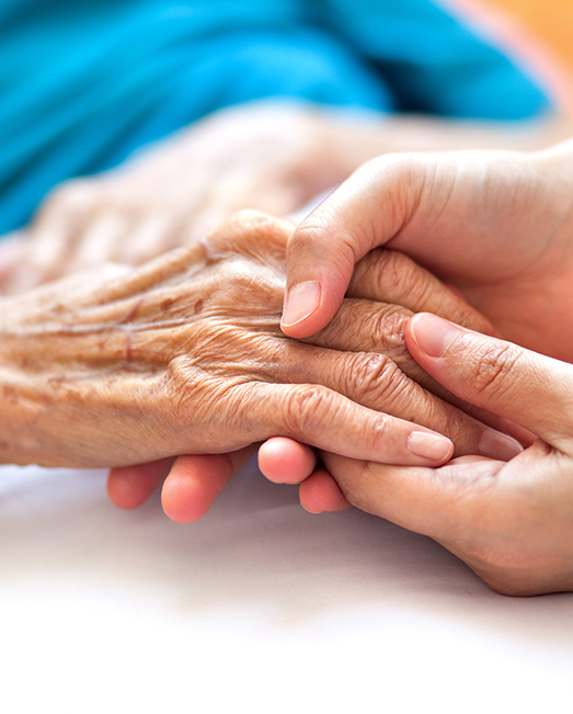 Young hands holding elderly hands