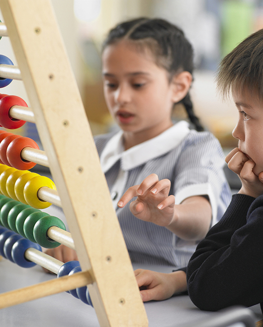 Primary school children using abacus.