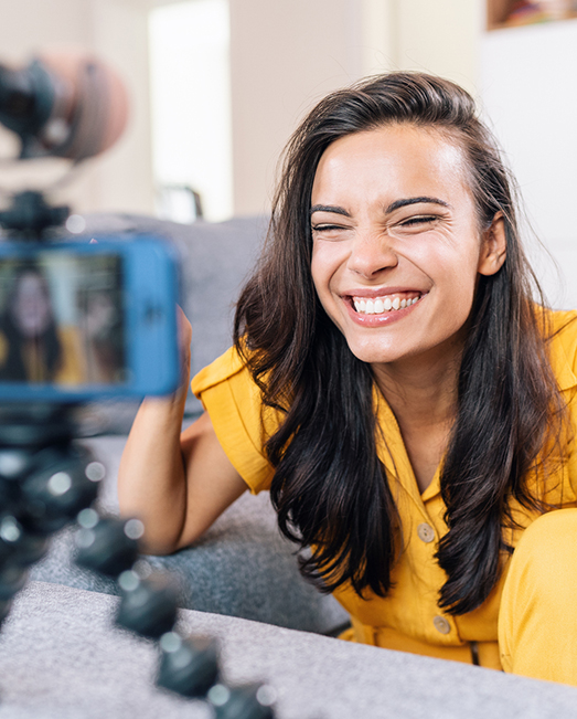 Girl smiling widely and taking a selfie