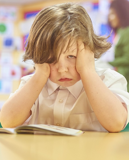 Young boy struggling with reading.
