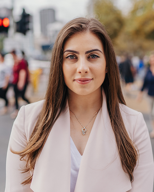 Jennifer Temelkovska standing on a busy footpath looking directly at camera.