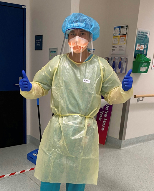 Adam Muncan dressed in PPE  giving thumbs up