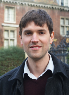 Portrait Dr Michael Champion out side a double story building.