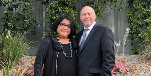 Phillip and Darlene current day in a garden wearing formal clothes.
