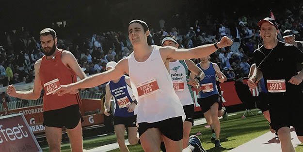 Running across the finish line in first marathon