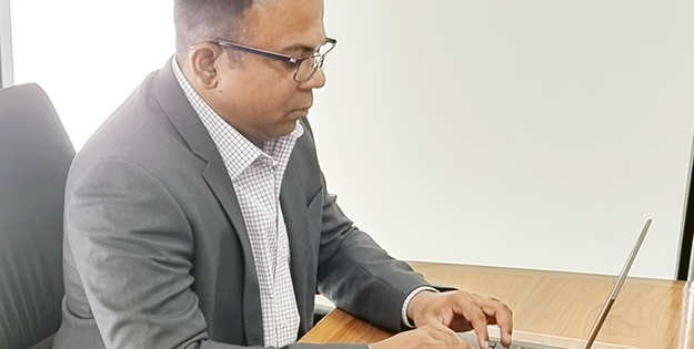 Sanjeev Alfred at his laptop