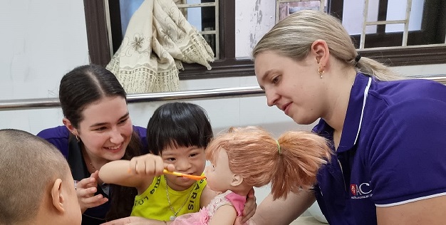 Two ACU OT students work with Vietnamese children