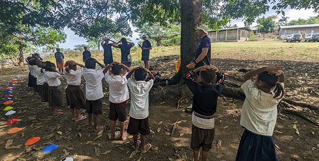ACU students interacting with schoolchildren in Timor-Leste.