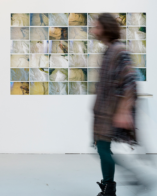person walking past a poster